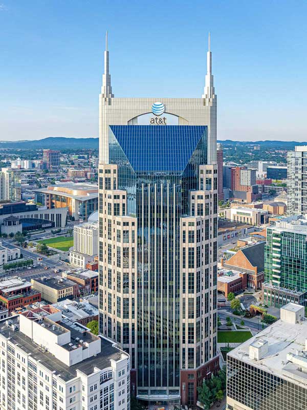 Aerial view of Nashville's Batman Building with the city and blue sky behind.